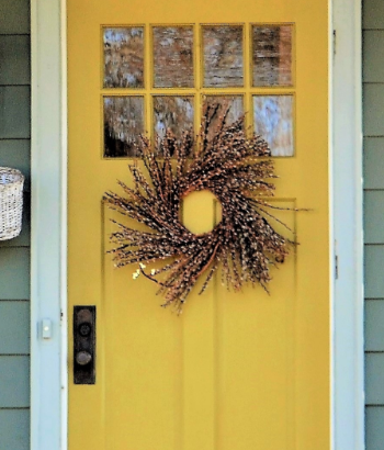 welcoming front door entrance painted a bright yel