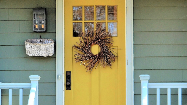 welcoming front door entrance painted a bright yel