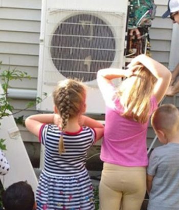 Children watching technician