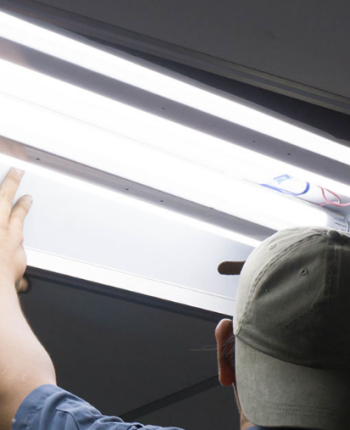 Man replacing a florescent light